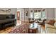 Elegant living room featuring hardwood floors, a decorative rug, and comfortable seating with great natural lighting at 1312 Glenden Falls Way, Raleigh, NC 27614