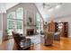 Bright and airy living room with high ceilings, large windows, a fireplace, and hardwood floors at 1312 Glenden Falls Way, Raleigh, NC 27614