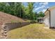 Spacious backyard featuring a retaining wall and lush greenery at 1344 Legend Oaks Drive Dr, Chapel Hill, NC 27517