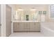 Elegant bathroom with double vanity, tub, walk-in shower, and quartz countertops at 1344 Legend Oaks Drive Dr, Chapel Hill, NC 27517