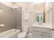Clean, renovated bathroom features grey tile, shower, and vanity at 1344 Legend Oaks Drive Dr, Chapel Hill, NC 27517