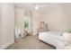 Bright bedroom with carpet, white trim, and a large window for natural light at 1344 Legend Oaks Drive Dr, Chapel Hill, NC 27517