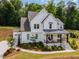 Charming home with white siding, covered porch, and lush landscaping on a well-maintained lawn at 1344 Legend Oaks Drive Dr, Chapel Hill, NC 27517