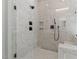 Modern bathroom featuring a glass shower, marble tiles, and black hardware at 1430 Clifton Pond Rd, Louisburg, NC 27549