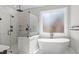 Modern bathroom featuring a glass shower and a free standing soaking tub at 1430 Clifton Pond Rd, Louisburg, NC 27549