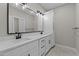 Bathroom with a double sink vanity with matte black hardware and a large mirror at 1430 Clifton Pond Rd, Louisburg, NC 27549
