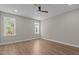 Bright bedroom featuring wood-look flooring, a ceiling fan, and a window with natural light at 1430 Clifton Pond Rd, Louisburg, NC 27549