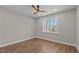 Bright bedroom featuring wood-look flooring, a ceiling fan, and a window with natural light at 1430 Clifton Pond Rd, Louisburg, NC 27549
