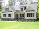 Inviting home features an attractive lawn, and stone accents, and metal awnings over the windows at 1430 Clifton Pond Rd, Louisburg, NC 27549