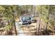 Beautiful aerial view of this modern farmhouse style home, nestled among mature trees with long driveway at 1430 Clifton Pond Rd, Louisburg, NC 27549