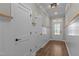 Well-lit hallway boasts board and batten trim, wood-look floors, and white doors with black hardware at 1430 Clifton Pond Rd, Louisburg, NC 27549