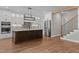 Spacious kitchen features a large island, stainless steel appliances, and hardwood floors at 1430 Clifton Pond Rd, Louisburg, NC 27549