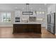 Bright kitchen with a large island, stainless steel appliances, and modern lighting at 1430 Clifton Pond Rd, Louisburg, NC 27549