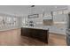 A chef's dream kitchen with marble countertops, gas stovetop, built in oven and a large island at 1430 Clifton Pond Rd, Louisburg, NC 27549