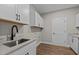 Functional laundry room featuring modern cabinetry, sleek countertops, and stainless sink at 1430 Clifton Pond Rd, Louisburg, NC 27549