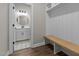 Mudroom with built-in bench and storage, and view into the stylish half bathroom at 1430 Clifton Pond Rd, Louisburg, NC 27549