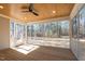 This screened porch features a wood ceiling, ceiling fan, wood flooring, and serene outdoor view at 1430 Clifton Pond Rd, Louisburg, NC 27549