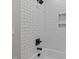 Beautiful shower featuring white subway tile surround, black fixtures, and niche shelving at 1430 Clifton Pond Rd, Louisburg, NC 27549