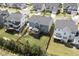 An aerial shot showcases the property's backyard, playset, and surrounding neighborhood at 155 Annabelle Branch Ln, Apex, NC 27523