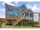 Home exterior showcasing a deck, screened porch, and lush green backyard at 155 Annabelle Branch Ln, Apex, NC 27523