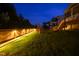 A spacious backyard featuring a wooden fence, playset, and lush green grass at 155 Annabelle Branch Ln, Apex, NC 27523