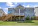 Spacious backyard featuring a large deck, screened porch, and well-manicured lawn at 155 Annabelle Branch Ln, Apex, NC 27523