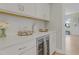 A stylish bar area features white cabinets, a wine fridge, quartz countertops, and a subway tile backsplash at 155 Annabelle Branch Ln, Apex, NC 27523