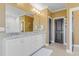 Bathroom featuring double sinks, vanity, decorative mirror, and a large walk-in shower with a neutral color palette at 155 Annabelle Branch Ln, Apex, NC 27523