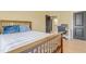 Cozy bedroom with a wooden bed frame, plush pillows, and neutral paint at 155 Annabelle Branch Ln, Apex, NC 27523