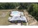 An aerial shot reveals a luxurious community pool surrounded by lush greenery and a clubhouse at 155 Annabelle Branch Ln, Apex, NC 27523