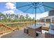Outdoor deck with shade umbrella and comfortable seating, overlooking lush greenery at 155 Annabelle Branch Ln, Apex, NC 27523