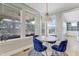 Bright dining area with stylish chairs, modern pendant lighting, and views of the screened porch at 155 Annabelle Branch Ln, Apex, NC 27523