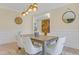 Elegant dining area with a wooden table, plush chairs, and a unique light fixture at 155 Annabelle Branch Ln, Apex, NC 27523
