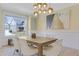 Well-lit dining room featuring a wood table, upholstered chairs, and a modern light fixture at 155 Annabelle Branch Ln, Apex, NC 27523
