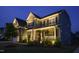 Inviting home exterior at dusk with manicured landscaping and warm lighting, perfect for evening gatherings at 155 Annabelle Branch Ln, Apex, NC 27523