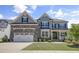 Beautiful home featuring a 2-car garage, a well-manicured lawn, and a classic craftsman-style covered front porch at 155 Annabelle Branch Ln, Apex, NC 27523