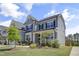 Charming two-story home with a well-manicured lawn and a welcoming front porch at 155 Annabelle Branch Ln, Apex, NC 27523