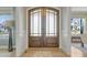 Elegant entryway featuring a beautiful double front door with glass panels and sidelights, leading into a welcoming foyer at 155 Annabelle Branch Ln, Apex, NC 27523