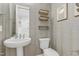 Stylish half bathroom with decorative wallpaper, floating shelves, and modern fixtures at 155 Annabelle Branch Ln, Apex, NC 27523