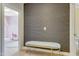 Hallway with a gray and gold bench and direct view of a room at 155 Annabelle Branch Ln, Apex, NC 27523