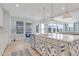 Open concept kitchen features bar seating at the kitchen island, stainless steel appliances and recessed lighting at 155 Annabelle Branch Ln, Apex, NC 27523