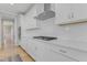 Kitchen with white cabinets, stainless steel appliances and modern gas cooktop at 155 Annabelle Branch Ln, Apex, NC 27523
