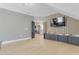 Open living room with sleek wood paneling and modern built-in media console at 155 Annabelle Branch Ln, Apex, NC 27523
