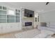Bright living room features a fireplace, built-in shelving and cabinets, and a neutral color palette at 155 Annabelle Branch Ln, Apex, NC 27523