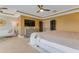 Spacious main bedroom featuring a sleek television, hardwood floors, couch and a comfortable queen-sized bed at 155 Annabelle Branch Ln, Apex, NC 27523