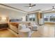 Spacious main bedroom boasts light wood floors, two chairs, and a large bed with decorative pillows at 155 Annabelle Branch Ln, Apex, NC 27523
