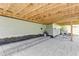 Spacious backyard patio featuring stone pavers and natural wood beams, perfect for outdoor relaxation at 155 Annabelle Branch Ln, Apex, NC 27523