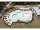 Aerial view of a uniquely shaped pool with plenty of seating and a shaded pergola at 155 Annabelle Branch Ln, Apex, NC 27523