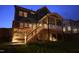 The rear exterior showcases a deck and screened porch with lighting at 155 Annabelle Branch Ln, Apex, NC 27523