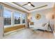 Bright sitting area featuring hardwood floors, large window, and a modern couch with gold accents at 155 Annabelle Branch Ln, Apex, NC 27523